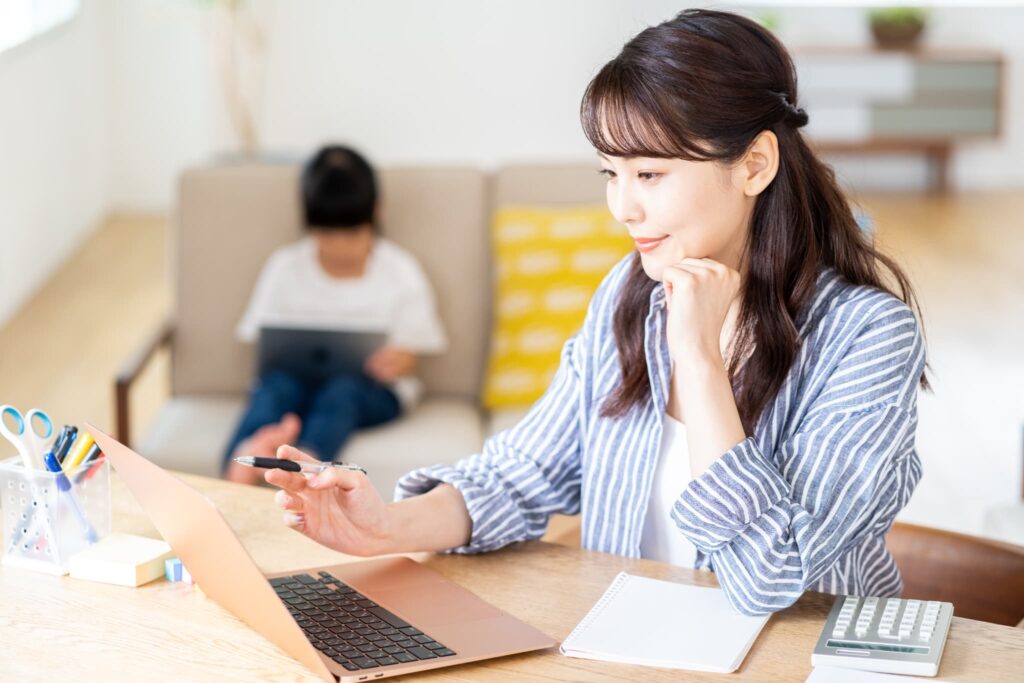 子どもと家にいながら勉強する女性